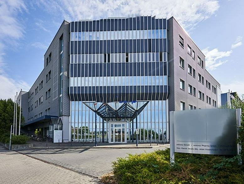 Exterior view of the modern glass and grey facade at Max-Planck-Straße 36.