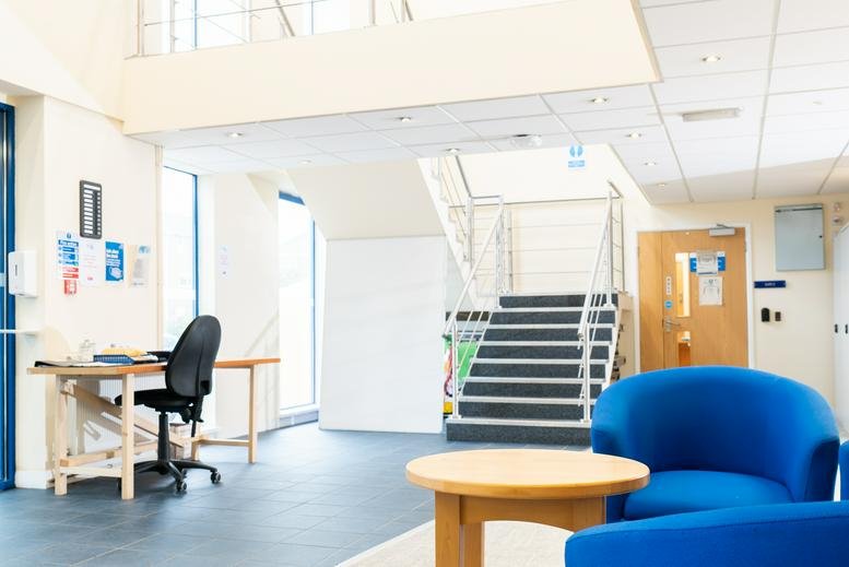 Spacious reception area of Meanygate, Bamber Bridge, Preston (Lancashire) featuring blue lounge chairs.