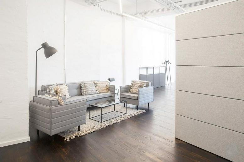 Spacious lounge area at Mehringdamm 33, 4th floor, Berlin, Berlin State with grey sofas and a floor lamp.