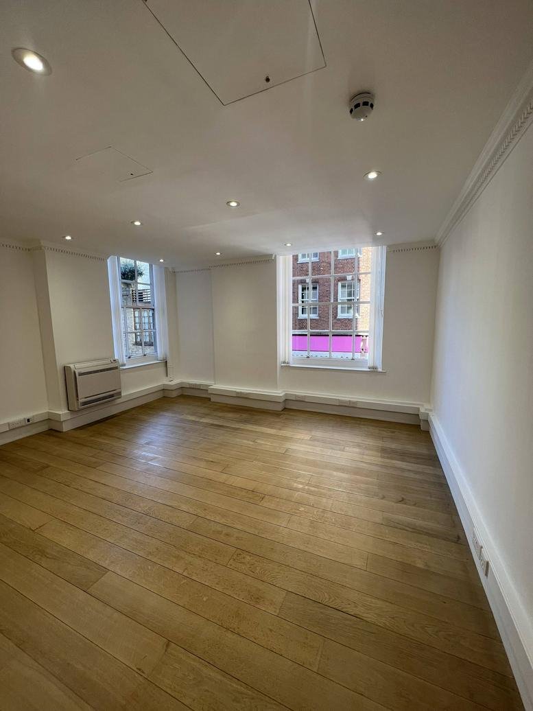 Spacious office interior at Messila House, 51 South Audley Street with wooden flooring and large windows.