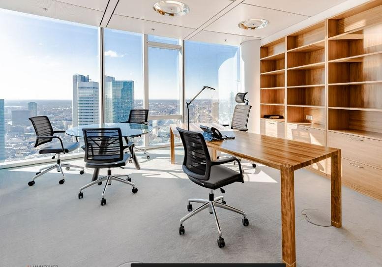 Spacious private office with wooden desks, a large bookshelf, and panoramic city views.