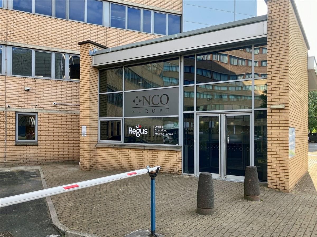 Exterior view of the brick facade and glass entrance at New City House.