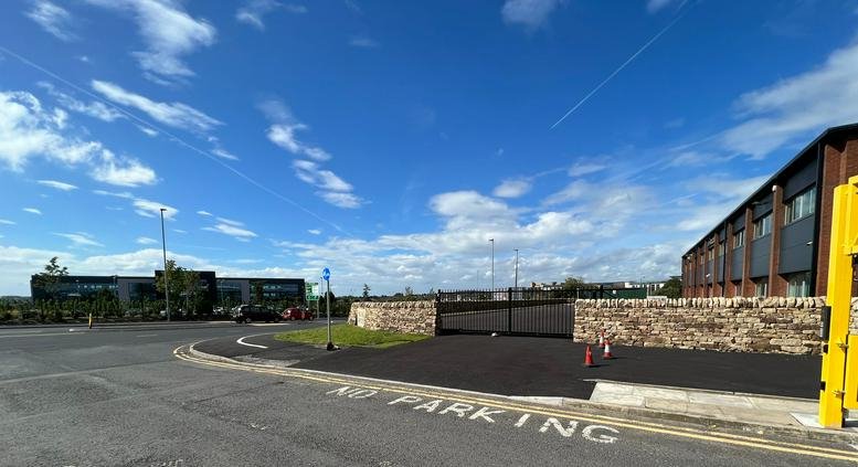 Exterior view of the modern stone and glass facade at NJK House, Haslingden Road.