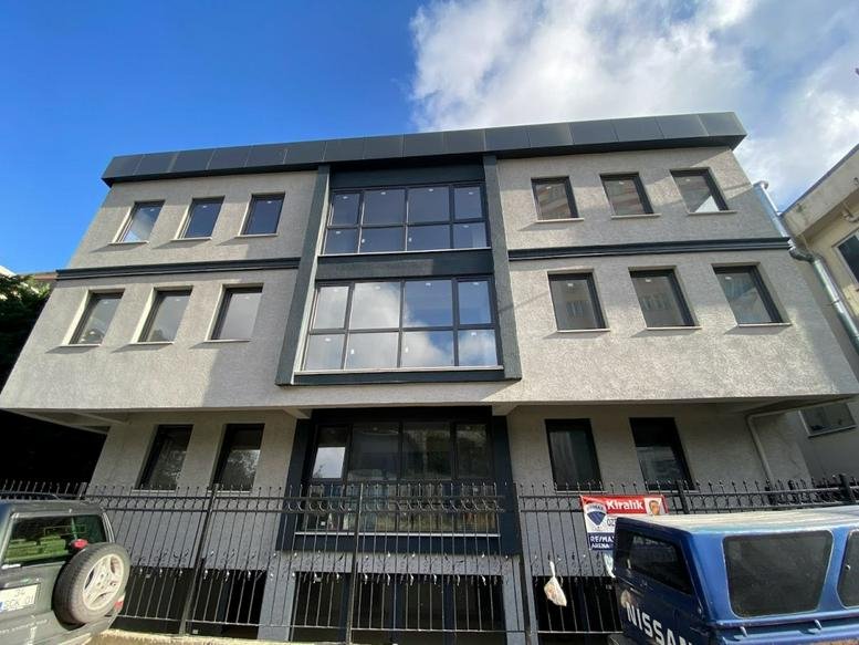 Exterior view of the modern grey and glass building at İnkılap, Umman Sk. 2-4.