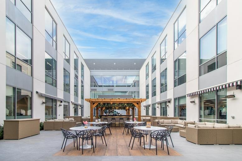 Exterior central courtyard at No. 5 The Heights, Brooklands, Weybridge with a wooden gazebo and patio seating.