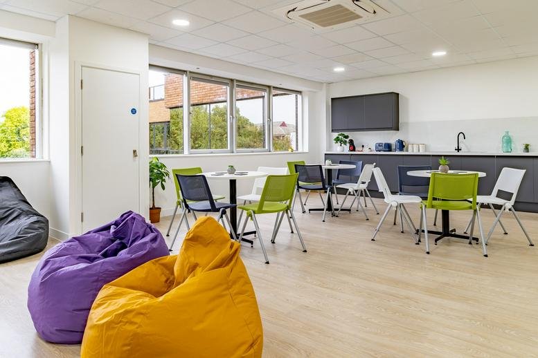 Spacious breakout area at Northminster House with colorful beanbags and café seating.