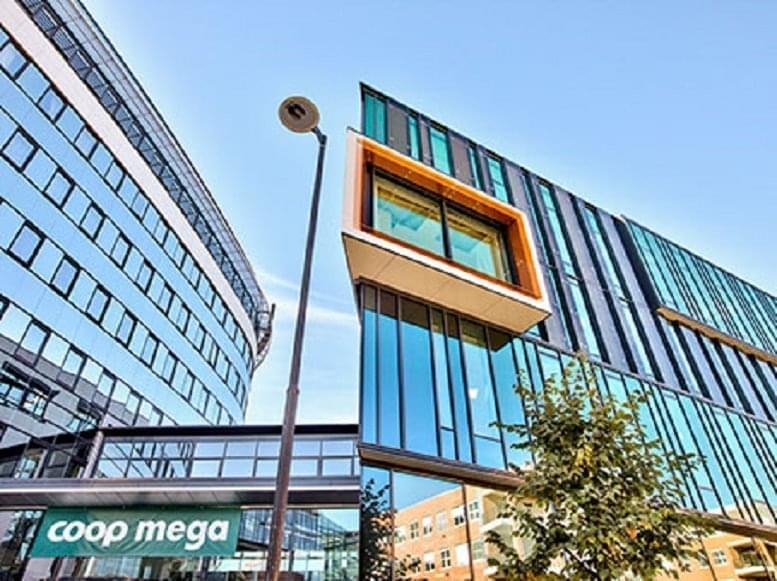 Modern glass-facade exterior of the building at Nydalsveien 33.