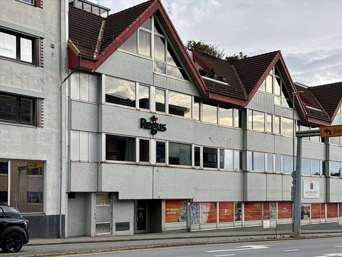 Exterior view of the light grey building at Oalsgata 7, 3rd Floor, Sandnes with red roof gables.