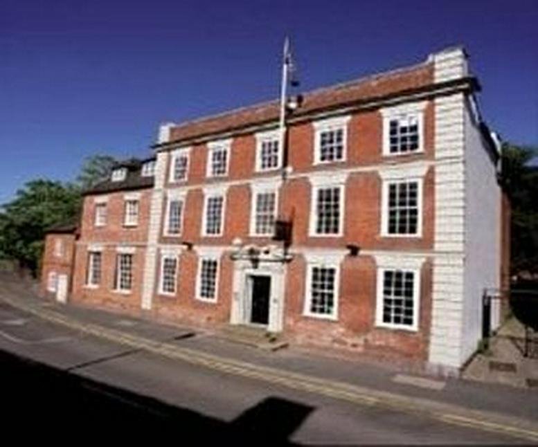 Exterior view of the historic red brick building at 1 High Street, Coleshill, Warwickshire.
