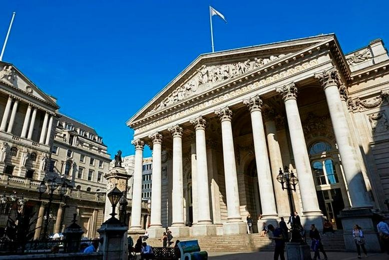 Exterior view of the historic stone pillars and grand facade of 1 Royal Exchange, Central London, EC3V.