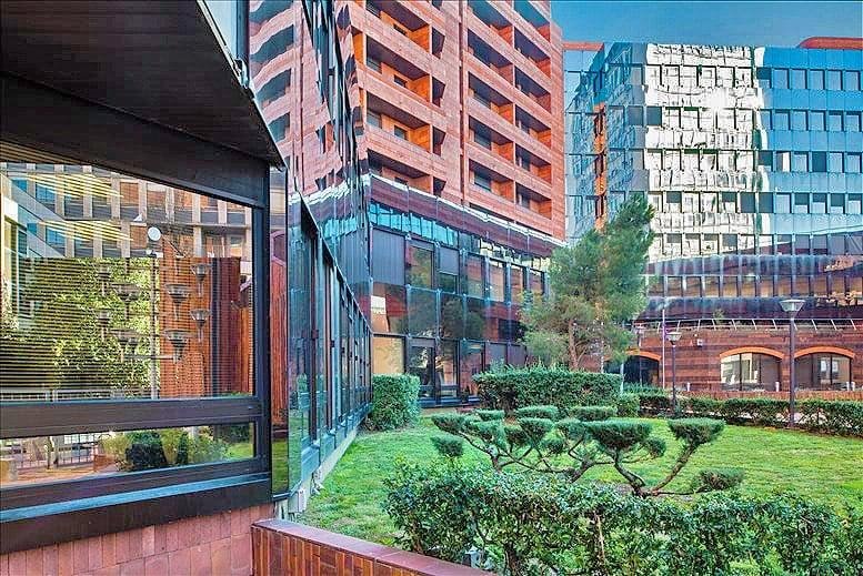 Exterior view of the multi-story brick and glass facade at 1 rue des pénitents blancs.