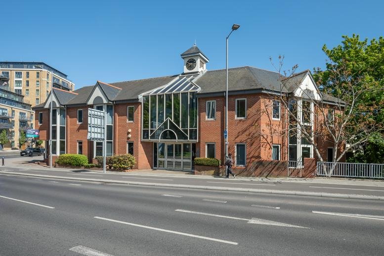 Exterior view of the brick facade and glass entrance at 1 Wheatfield Way, Kingston Upon Thames.