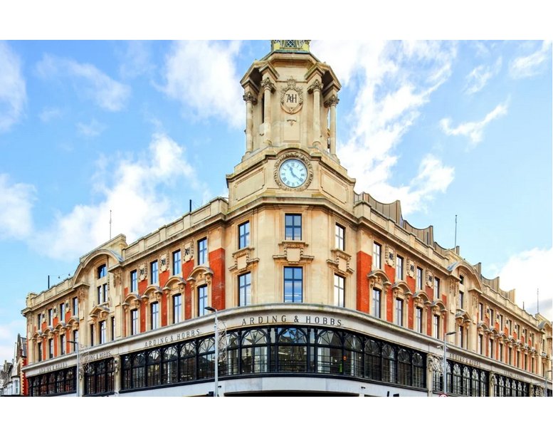Grand exterior of 10 Saint John's Road, Clapham Junction, featuring a prominent clock tower and red brick facade.