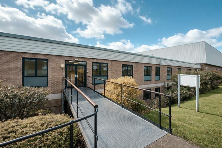 Exterior facade of Airport Business Centre, 10 Thornbury Road, with an accessible ramp leading to the entrance.