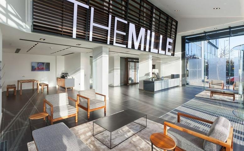 Exterior view of The Mille building with signage.