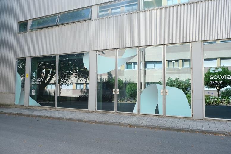 Exterior facade of the building at 106A, Rua Álvaro Gomes, Porto, Portugal showing large glass windows.