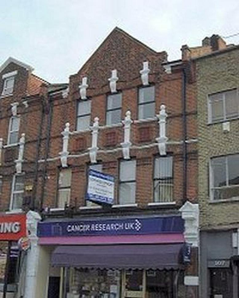 Exterior view of the brick facade at 109 George Lane with Cancer Research UK shopfront.