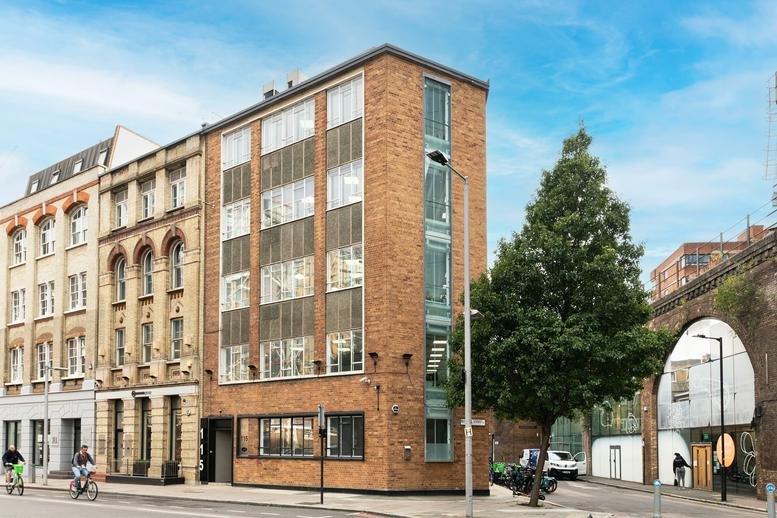 Exterior view of the brick facade and large windows of 115 Southwark Street.
