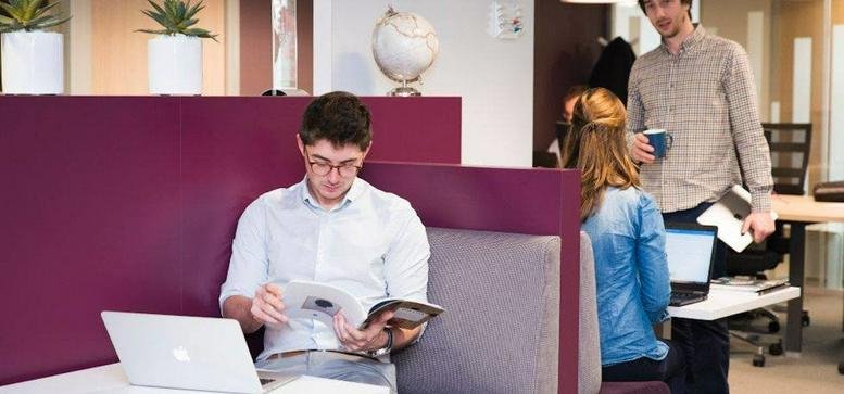 Coworking space at 12 Avenue Carnot, Nantes featuring high-backed purple privacy booths and modern workstations.