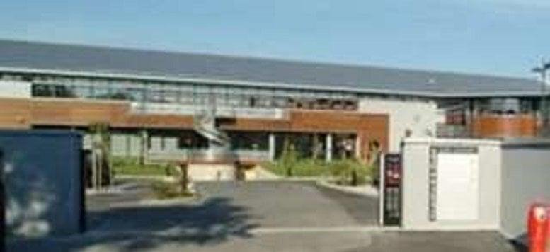 Exterior view of the modern glass and wood facade of the building at 12 Avenue des Saules.