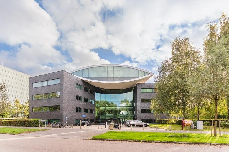 Exterior view of the ClubSpace building with its unique curved glass roof and modern facade.