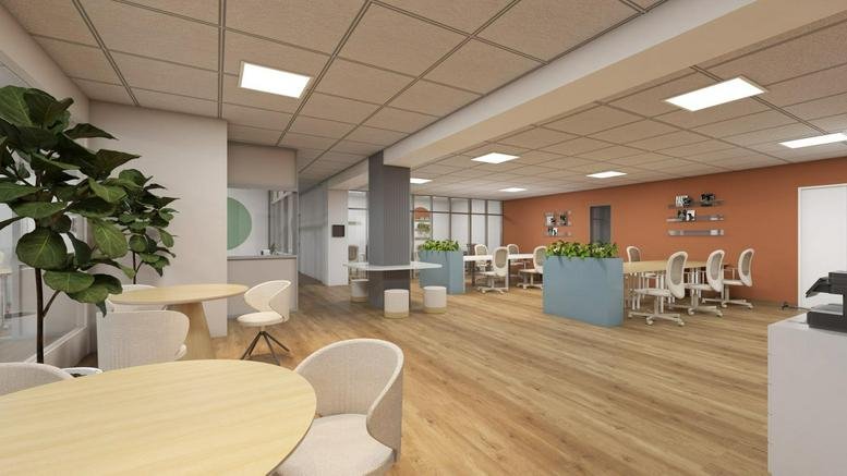 Spacious open-plan coworking area at 120, Carrer de París, Barcelona with warm wood floors and abundant plants.