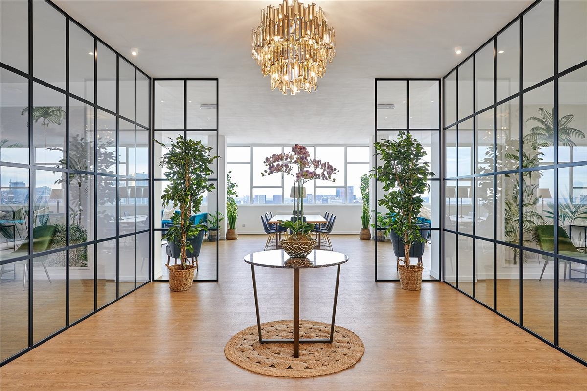 Bright open-plan area featuring industrial glass partitions and wooden floors at 120 Vyse Street.