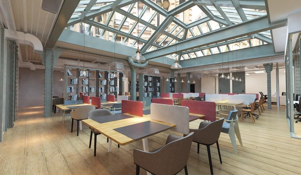 Spacious communal lounge at 124 rue Réaumur featuring a large decorative glass atrium and colorful seating.