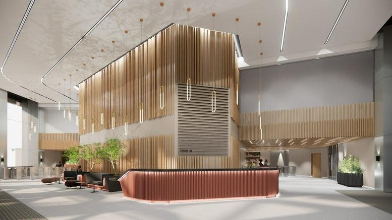 Grand lobby and reception area at 125 Old Broad Street with wood slat walls and warm lighting.