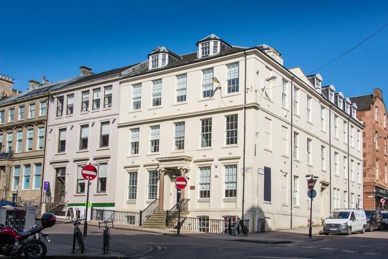 Exterior view of the historic white facade of 126 West Regent Street.