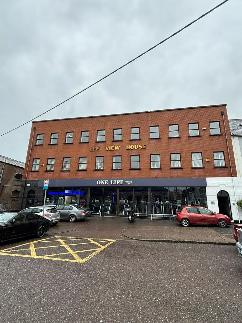 Red brick exterior of the 13 South Terrace building featuring large windows.
