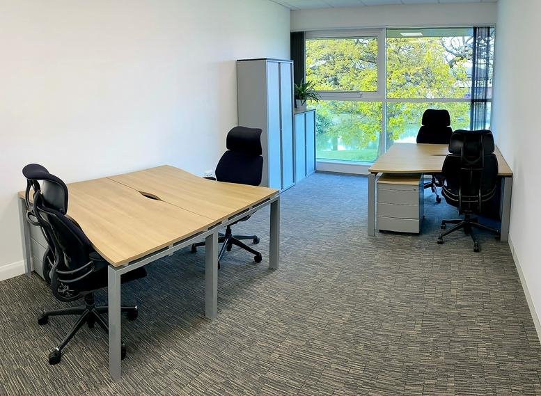 Spacious boardroom at 1310 Parkway, Birmingham Business Park with a large table and ergonomic chairs.