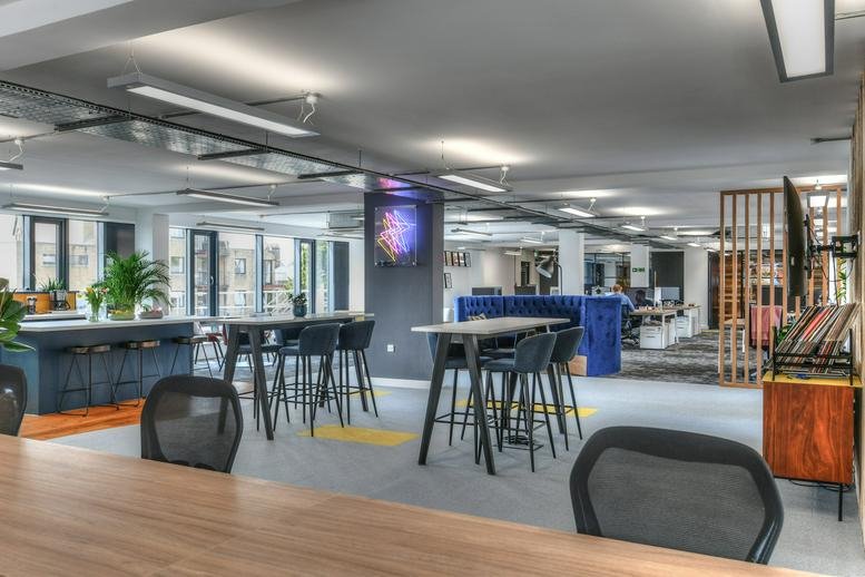 Spacious interior of Tyndale House, 134 Cowley Road featuring modern communal tables and breakout zones.
