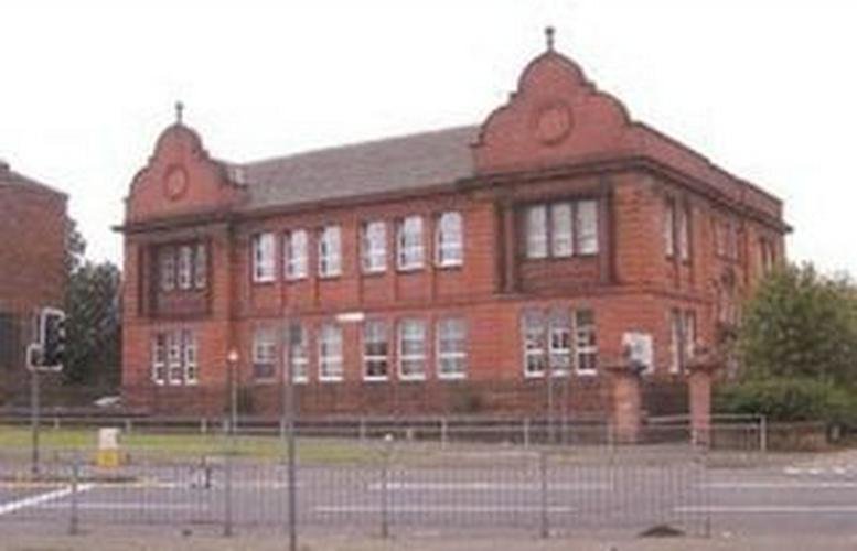 Exterior view of the red brick building at 1346 Shettleston Road, Glasgow, Scotland featuring ornate gables.