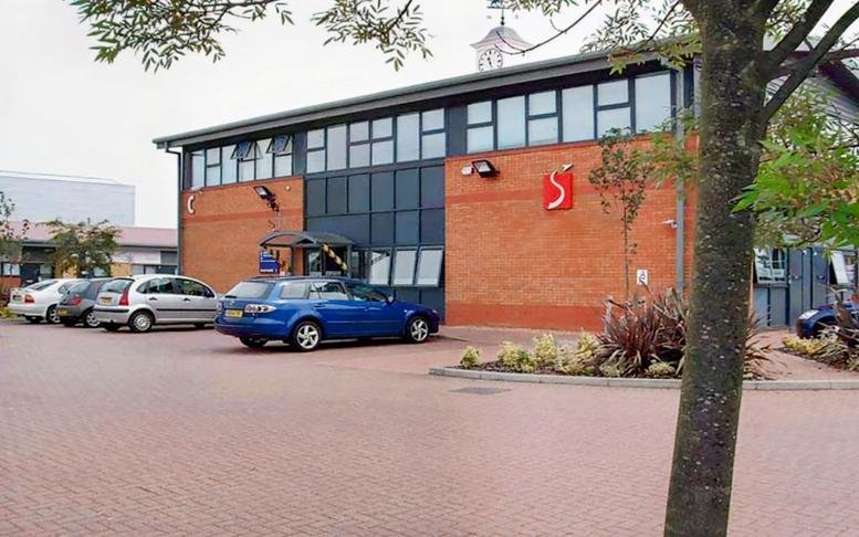 Exterior view of the brick facade and parking area at 14 Cumberland Avenue.
