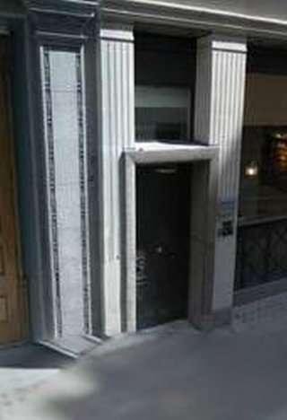 Ground level exterior entrance with fluted stone pillars at 14 King Street, 4th Floor, Central London.