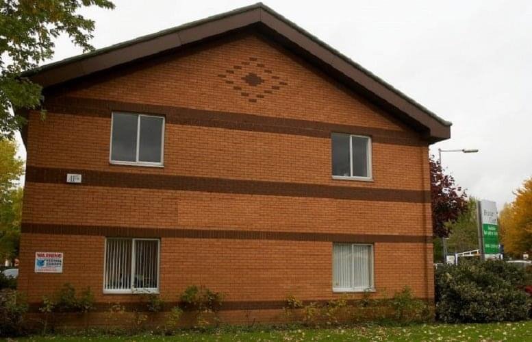 Side view of Somerset House, Hussar Court showing the brick exterior and pitched roof.