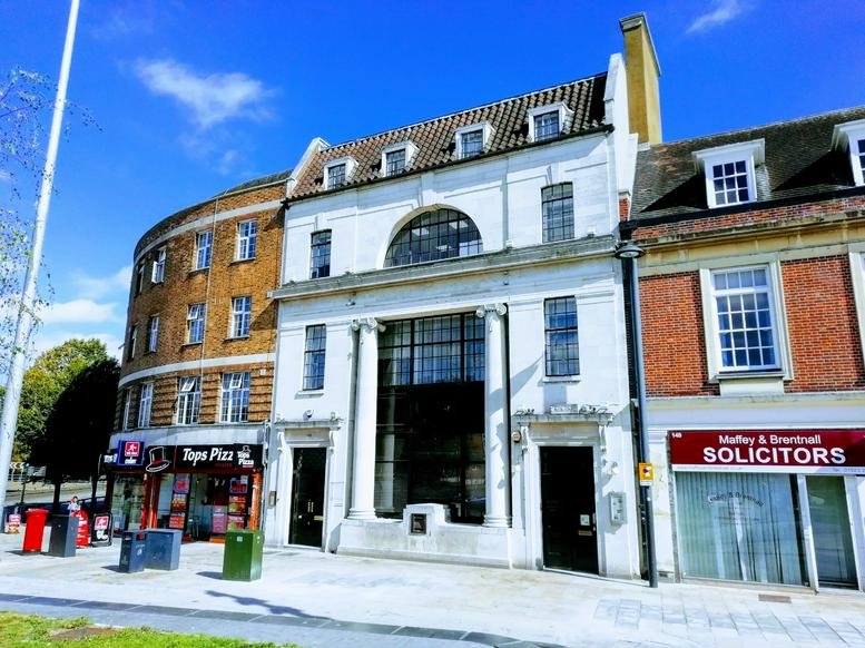 Exterior view of the historic white facade of The Old Bank, 153 The Parade.