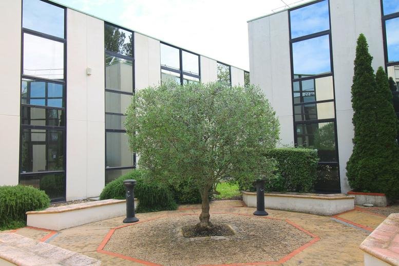 Exterior view of the modern glass and white facade at 16 Avenue de l’Europe, Ramonville Saint Agne.