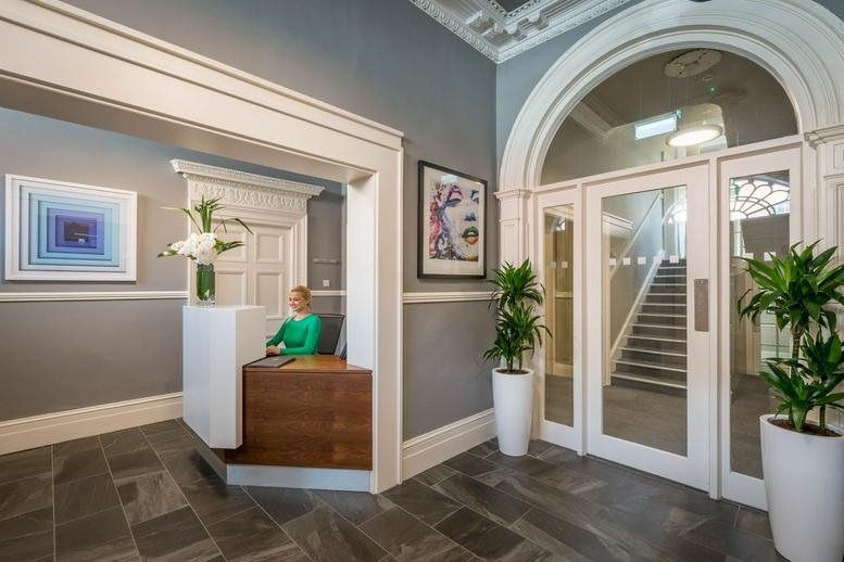 Grand reception at 16 Fitzwilliam Place with an arched doorway and marble flooring.