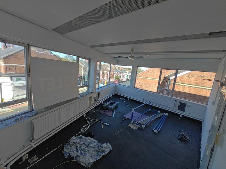 Bright corner office area at 17 Boldon Lane featuring expansive windows and plenty of natural light.