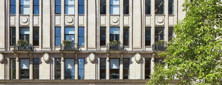 Classic stone facade and large windows of The Smiths Building at 179 Great Portland Street.