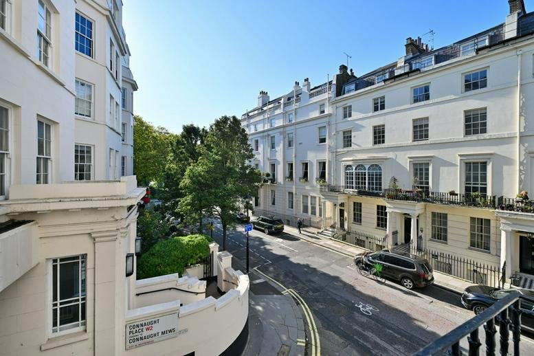 Elevated street view showing the surrounding historic white buildings and neighborhood greenery.