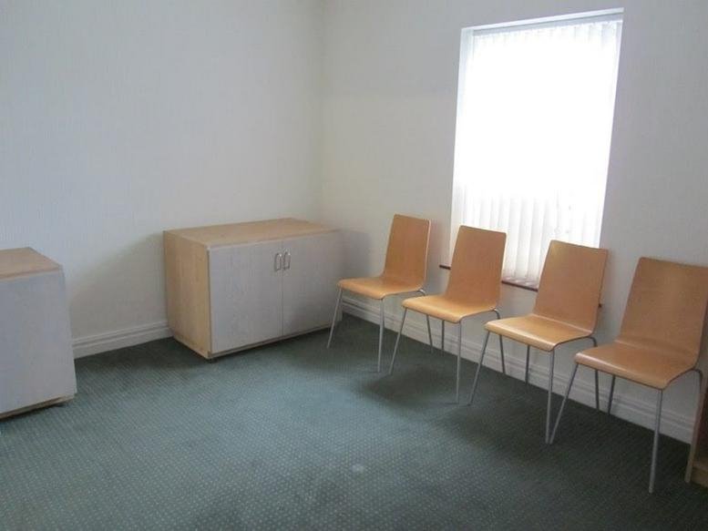 Waiting area with wooden chairs and storage units at 188 Rainhill Road, 1st Floor.