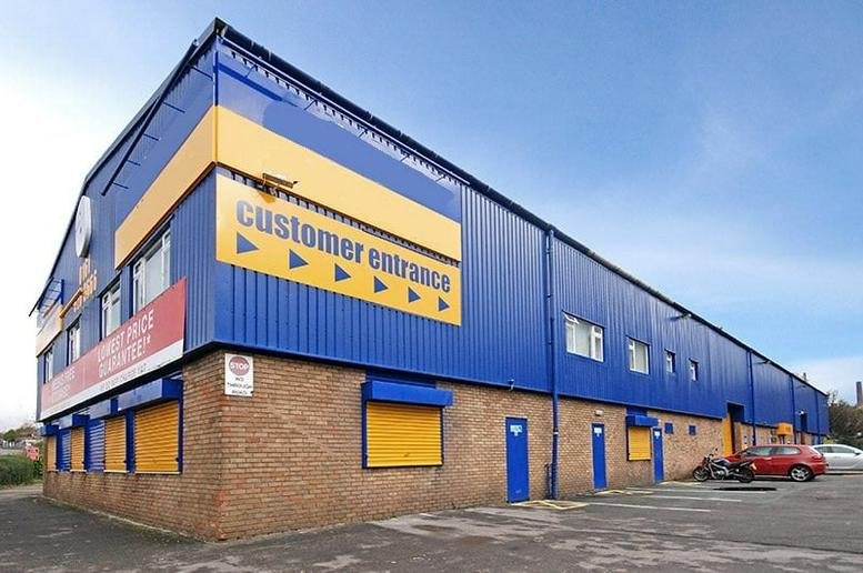 Exterior view of the blue and yellow building at 189 Manchester Road, Oldham, Lancashire.