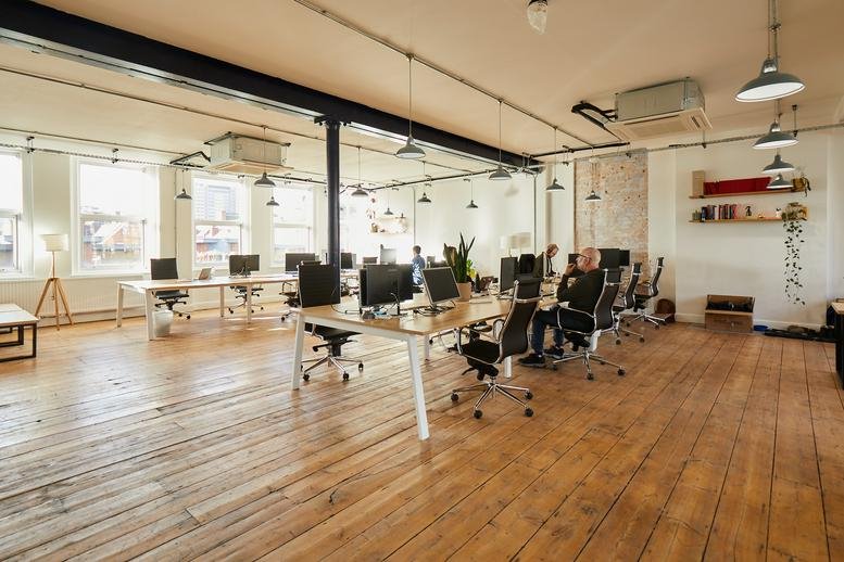 Spacious open-plan workspace at Overseas House, 19-23 Ironmonger Row with wood floors and abundant natural light.