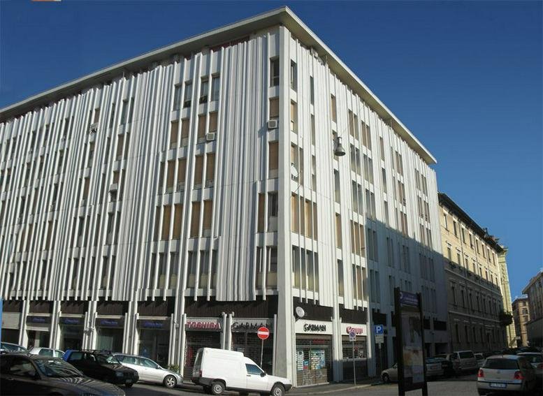 Exterior view of the multi-story white facade at 19 Via Attilio Regolo, Rome, Italy.