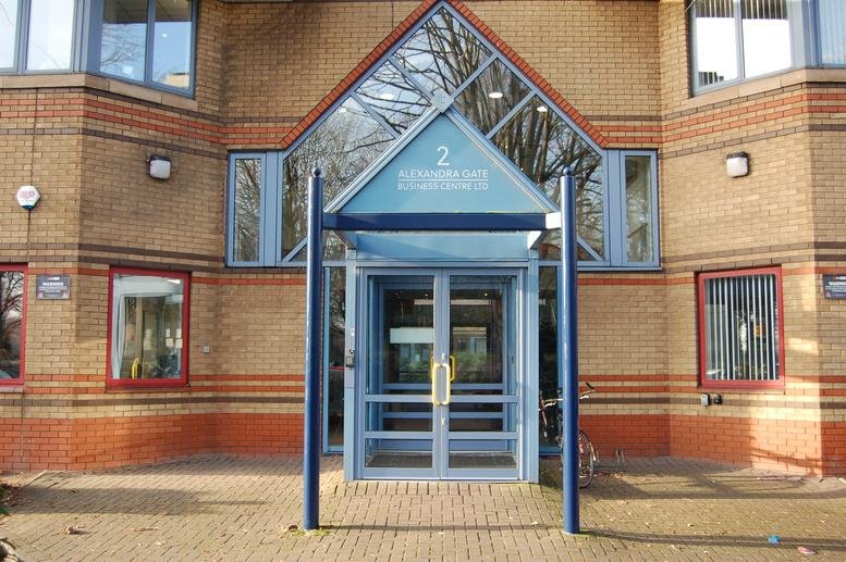Exterior entrance of Alexandra Gate Business Centre with blue glass gable and brick facade.