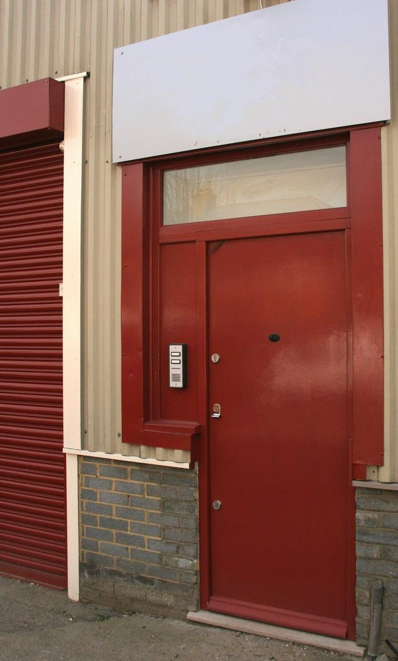 Red entryway and roller shutter door at 2 Thayers Farm Road, Clock House, Beckenham, South East London.