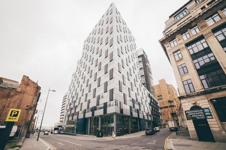 Exterior view of the white geometric-patterned facade of 20 Chapel Street, Liverpool.